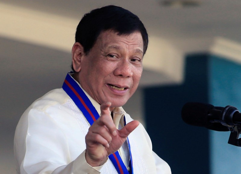 Philippine President Rodrigo Duterte gestures as he delivers his speech during the 116th Police Service Anniversary inside the Philippine National Police (PNP) headquarters in Quezon city