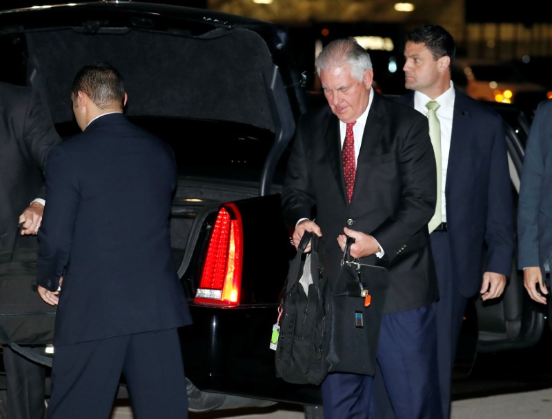 U.S. Secretary of State Rex Tillerson gathers his things to board his plane to depart for a several day Mideast trip, Friday, Oct. 20, 2017, in Andrews Air Force Base, Md