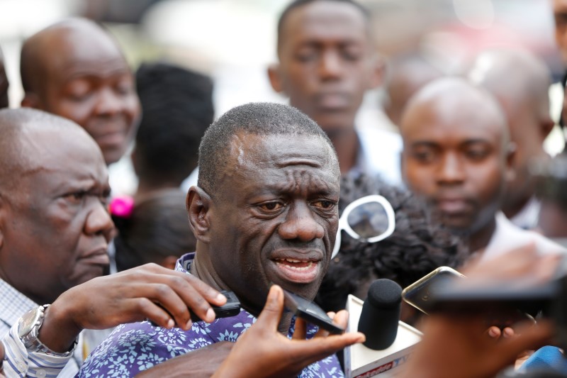Uganda's main opposition leader, Kizza Besigye of the Forum for Democratic Change (FDC) party (C), speaks to the media at the high court, in the capital Kampala