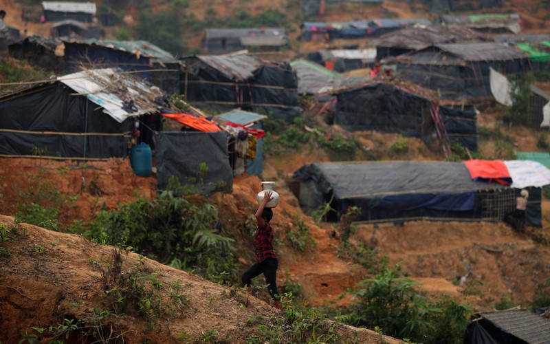 A Rohingya refugee child carries water through Palong Khali refugee camp near Cox's Bazar