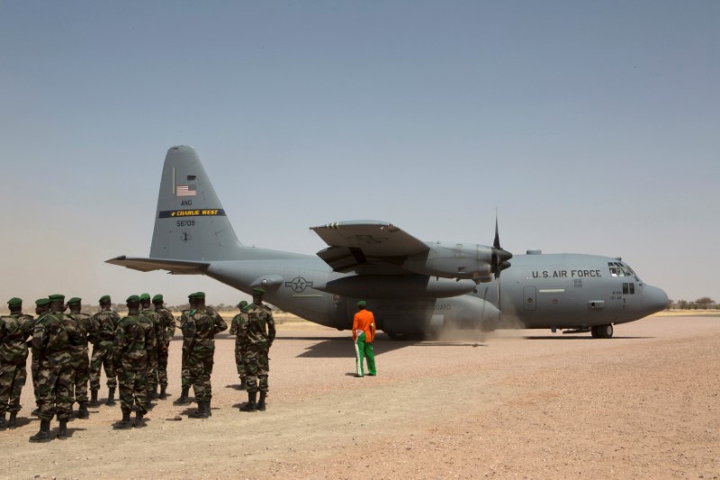 FILE PHOTO: A C-130 U.S. Air Force plane lands as Nigerien soldiers stand in formation during the Flintlock military exercise in Diffa