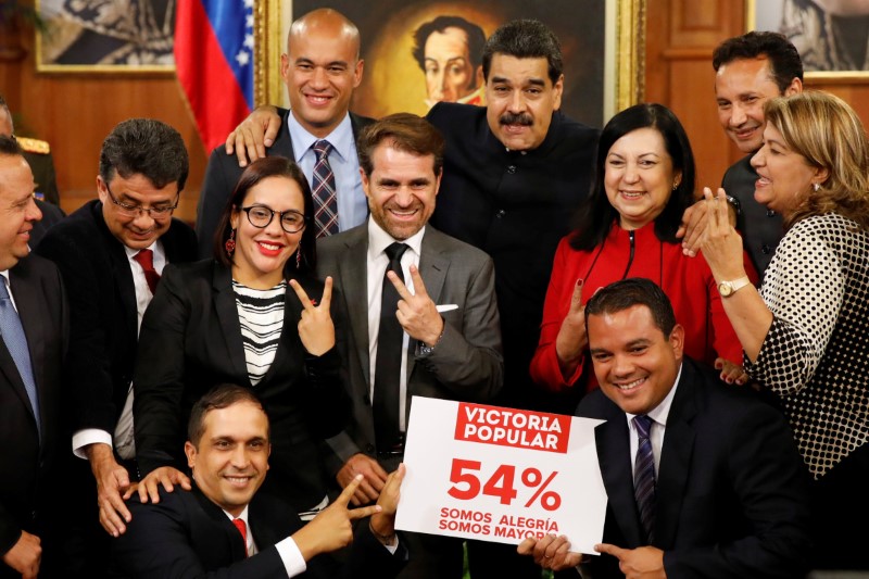 Venezuela's President Nicolas Maduro poses for a picture with new elected governors after a news conference at Miraflores Palace in Caracas