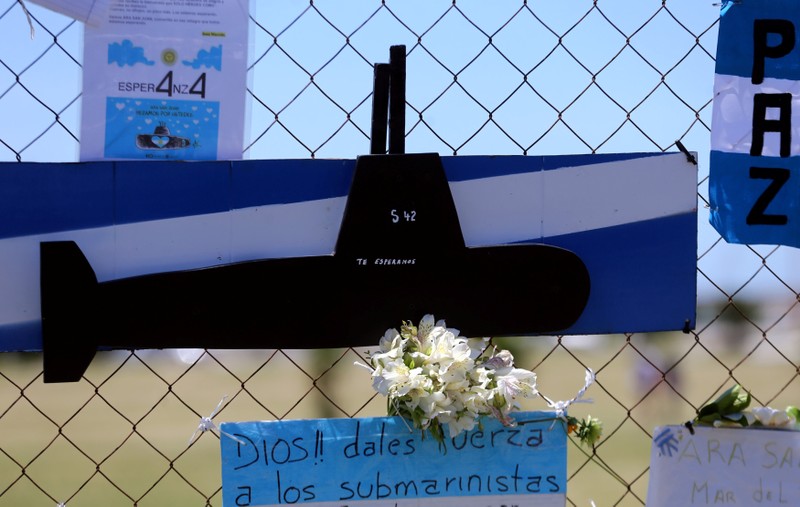A bouquet of flowers and banners in support of the 44 crew members of the missing at sea ARA San Juan submarine are placed on a fence outside an Argentine naval base in Mar del Plata