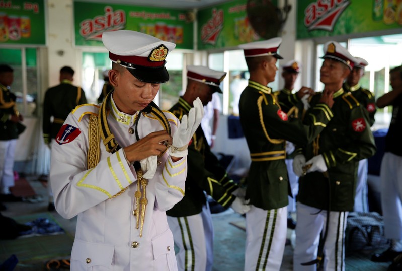 Members of the honour guard put on their uniforms before the arrival of Pope Francis at the Presidential Palace in Naypyitaw, Myanmar