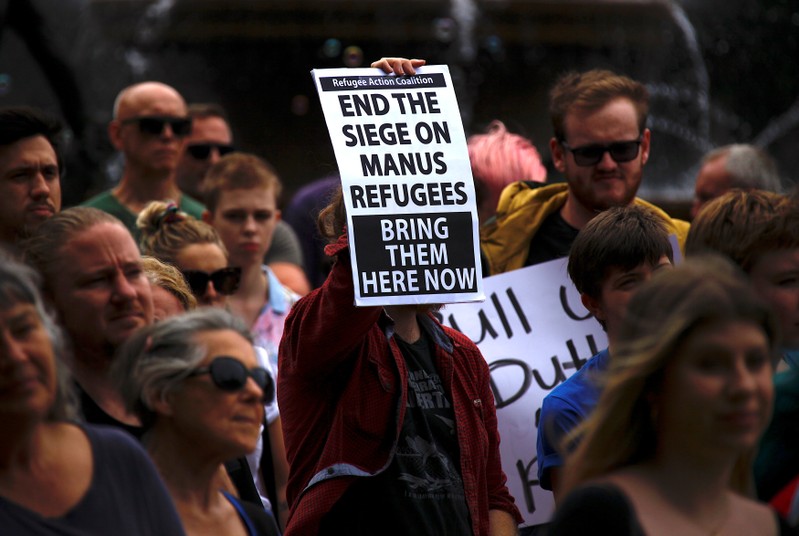 Refugee advocates hold placards as they participate in a protest in Sydney, Australia, against the treatment of asylum-seekers at Australia-run detention centres located at Nauru and Manus Island