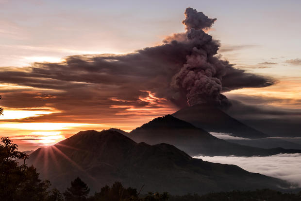 Bali’s airport reopens, but volcano threat still looms