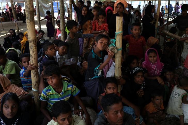 Rohingya refugees wait at a relief centre after crossing the Bangladesh-Myanmar border in the Teknaf area