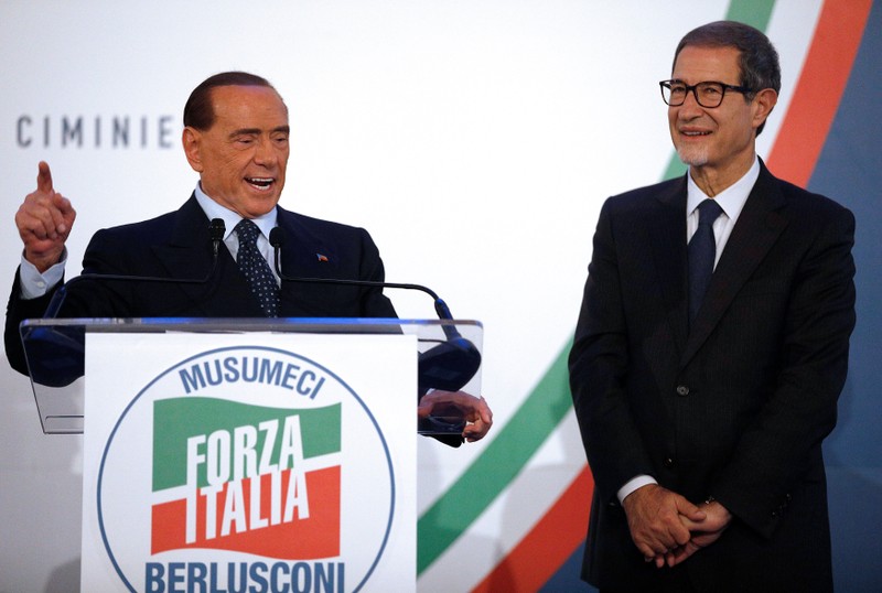 Forza Italia party leader Silvio Berlusconi speaks next to local candidate Nello Musumeci during a rally in Catania
