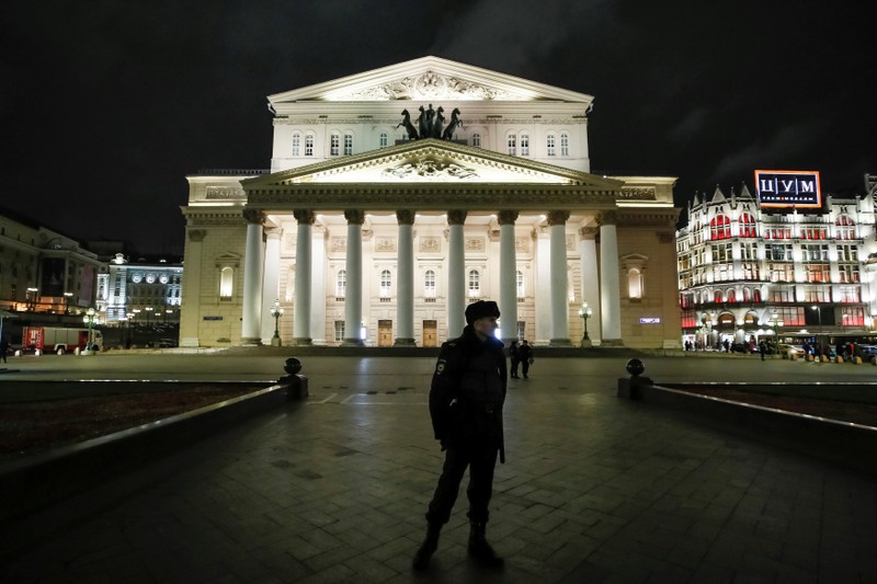A police officer secures an area in front of the Bolshoi theater after bomb threats in Moscow