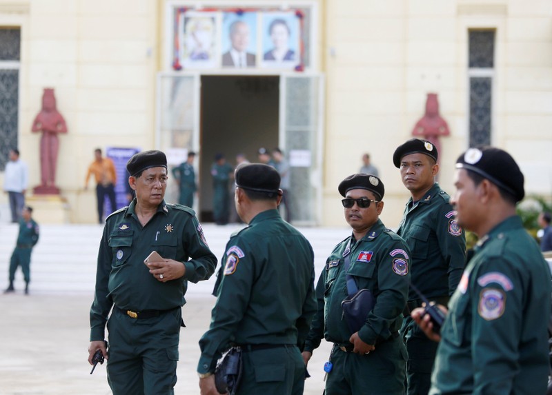 Police officers stand guard at the Supreme Court during a hearing in Phnom Penh