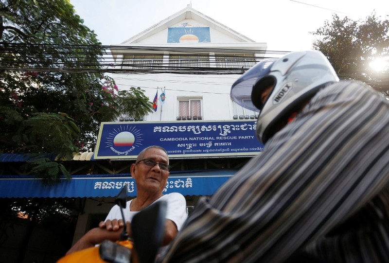 Men stand in front of the Cambodia National Rescue Party (CNRP) headquarters in Phnom Penh