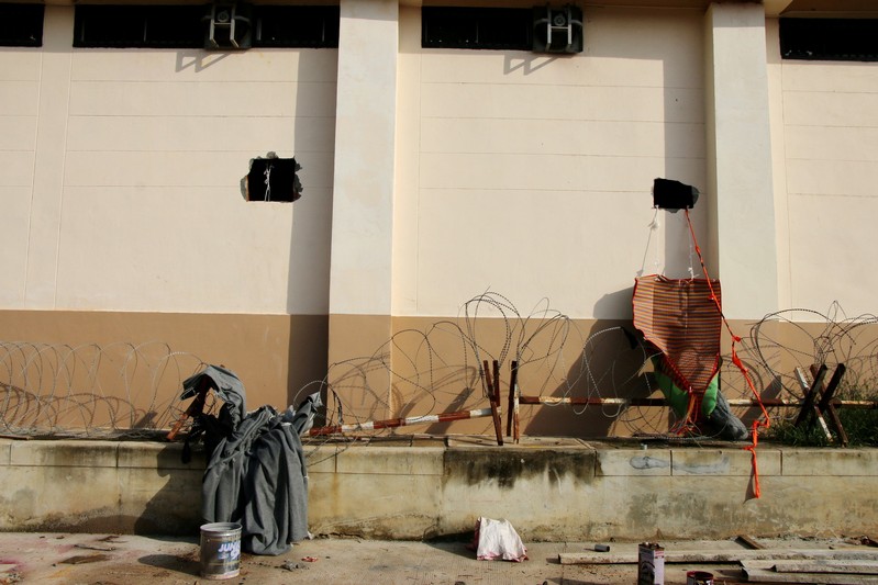 Square holes in a wall of a detention center are seen near the Thailand-Malaysia border in Hatyai