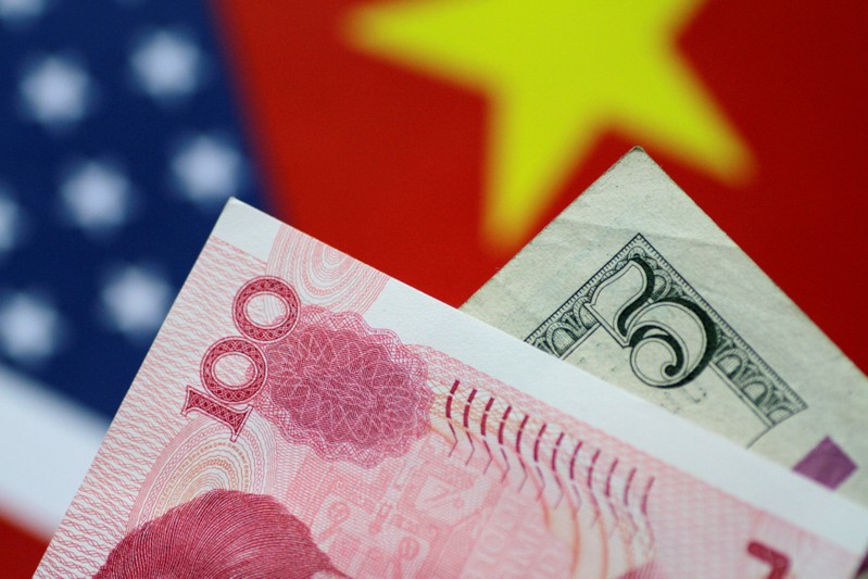 FILE PHOTO: Illustration photo of U.S. Dollar and China Yuan notes