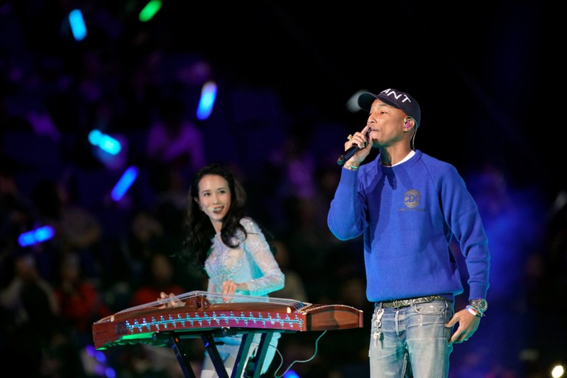 U.S. singer Pharrell Williams and Hong Kong singer Karen Mok perform during Alibaba Group's 11.11 Singles' Day global shopping festival in Shanghai