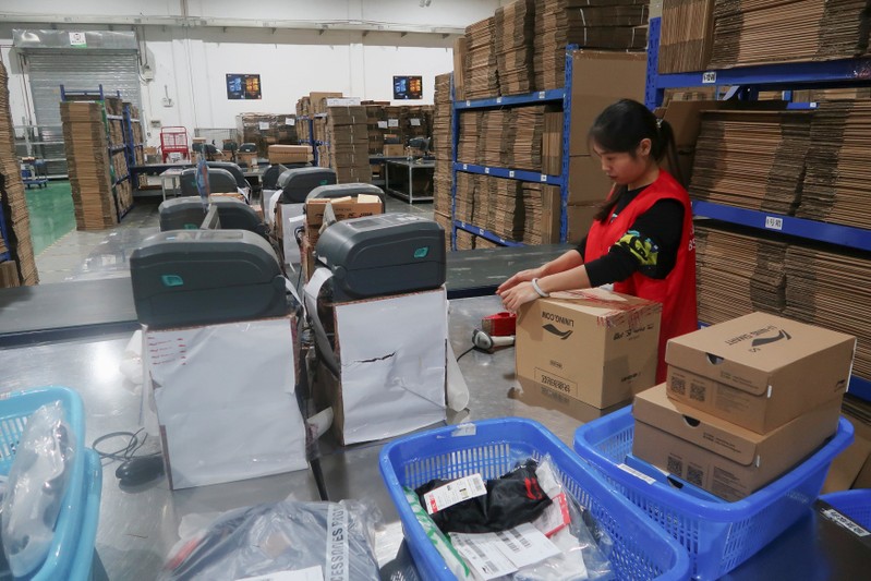 A BEST Inc employee scans parcels at one of the company's Shanghai order fulfillment centres in Shanghai