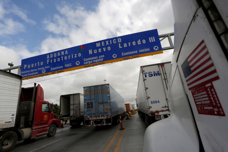 FILE PHOTO: Trucks wait in the queue for border customs control to cross into U.S. at the World Trade Bridge in Nuevo Laredo