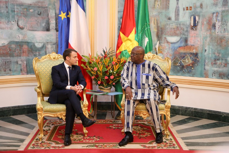French President Emmanuel Macron attends a meeting with Burkina Faso's President Roch Marc Christian Kabore at the Presidential Palace in Ouagadougou