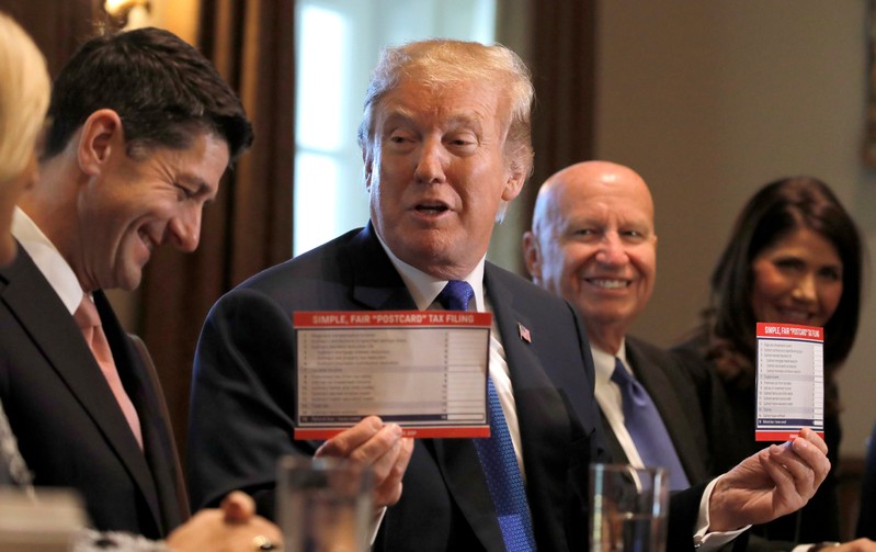 U.S. President Trump holds sample tax forms as he promotes tax plan at the White House in Washington