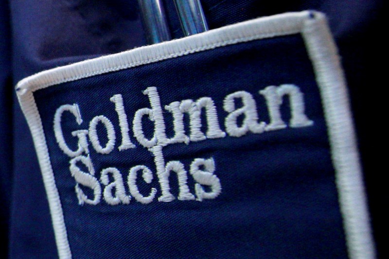 FILE PHOTO: The logo of Dow Jones Industrial Average stock market index listed company Goldman Sachs (GS) is seen on the clothing of a trader working at the Goldman Sachs stall on the floor of the New York Stock Exchange