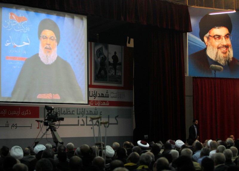 Lebanon's Hezbollah leader Sayyed Hassan Nasrallah is seen on a video screen as he addresses his supporters in Beirut