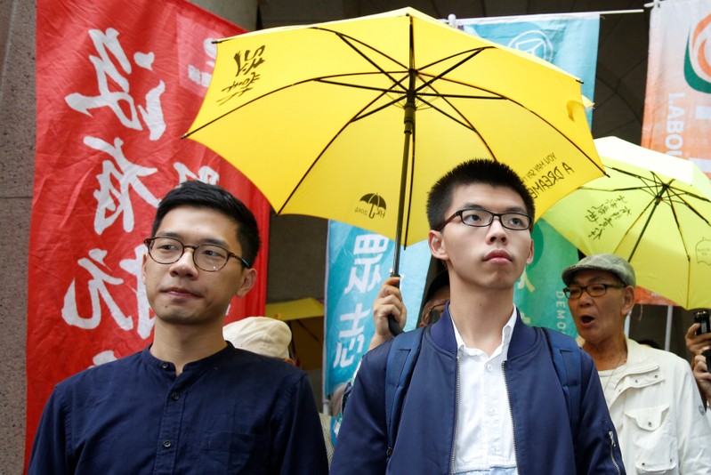 Pro-democracy activists Joshua Wong (R) and Nathan Law arrive at the Court of Final Appeal in Hong Kong