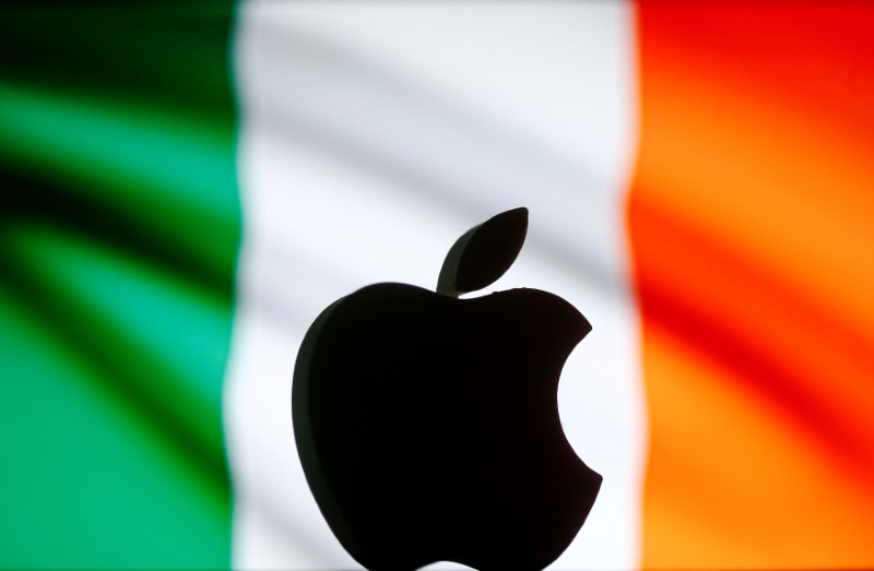 A 3D printed Apple logo is seen in front of a displayed Irish flag in this illustration
