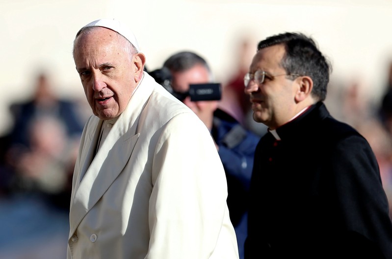 Pope Francis looks as he arrives during his Wednesday general audience in Saint Peter's square at the Vatican