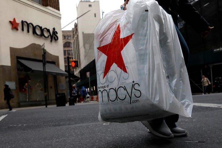 A customer exits after shopping at a Macy's store in the Brooklyn borough of New York
