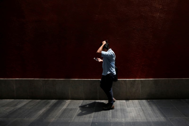 Man looks at his phone in Mexico City,