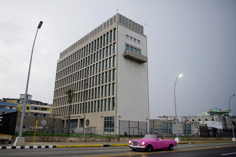 A car with tourists drives past the U.S. Embassy in Havana, Cuba