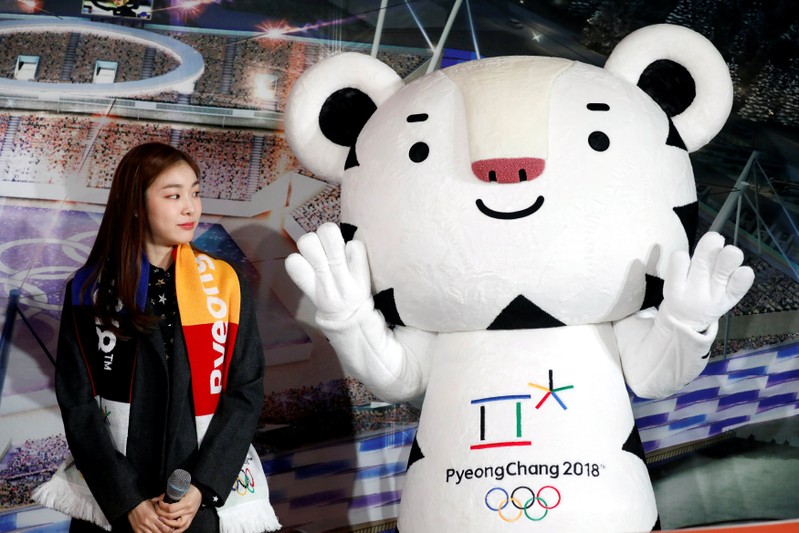 FILE PHOTO: Kim Yuna looks at the Olympic mascot 
