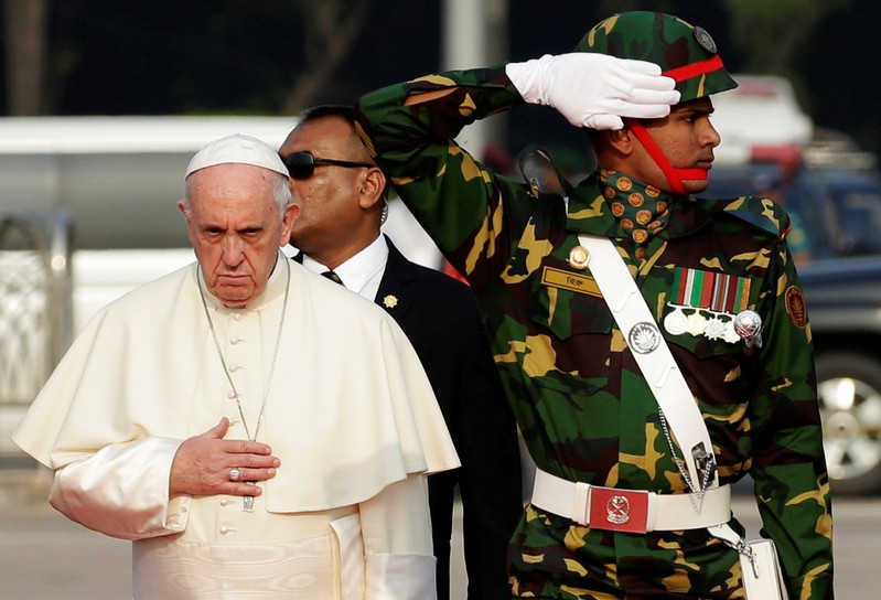 Pope Francis attends a welcome ceremony after arriving at the airport in Dhaka