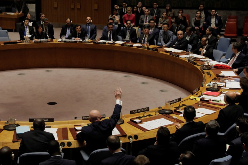 Representatives of Russia and Bolivia vote in the UN Security Council on a bid to renew an international inquiry into chemical weapons attacks in Syria during a meeting at the UN headquarters in New York