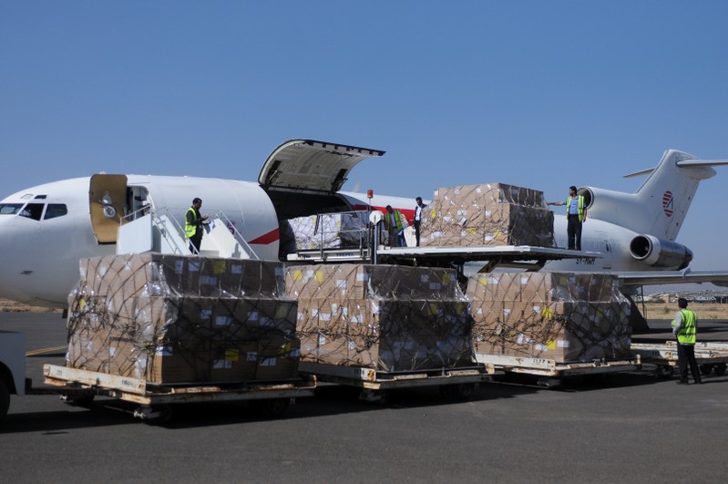 Workers unload aid shipment from a plane at the Sanaa airport