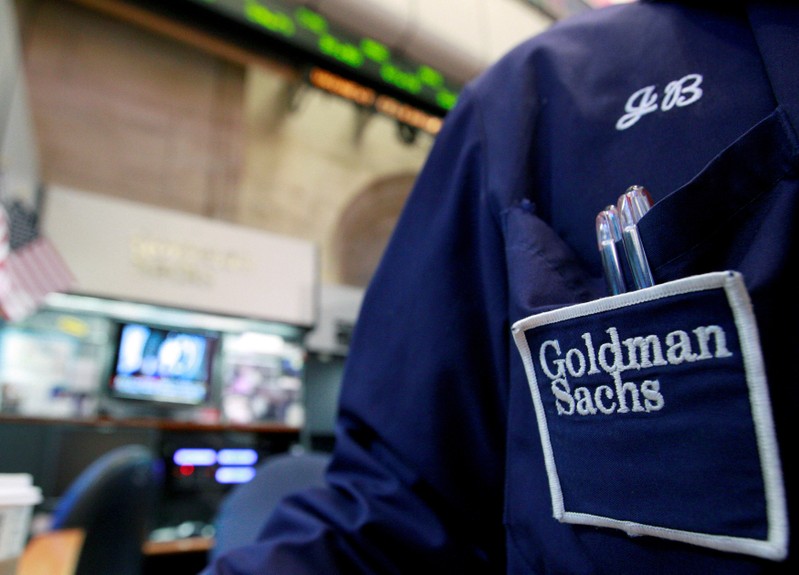 FILE PHOTO: A trader works at the Goldman Sachs stall on the floor of the New York Stock Exchange