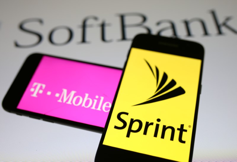 Smartphones with the logos of T-Mobile and Sprint are seen in front of a Soft Bank logo in this illustration