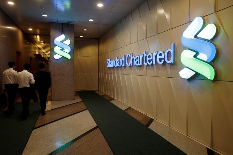 People walk inside the main branch of Standard Chartered in Hong Kong