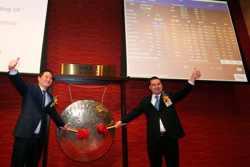 China Literature Co-Chief Executive Officers Liang Xiaodong and Wu Wenhui pose during the debut of the company in Hong Kong