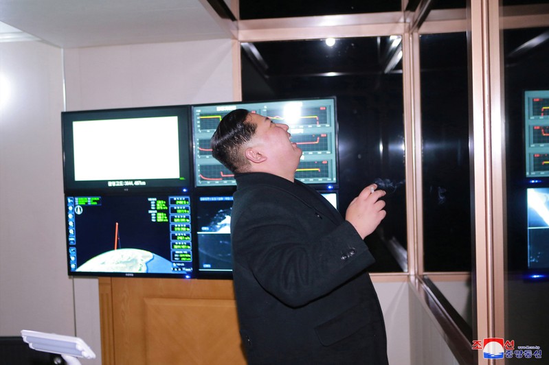 North Korea's leader Kim Jong Un is seen as the newly developed intercontinental ballistic rocket Hwasong-15's test was successfully launched