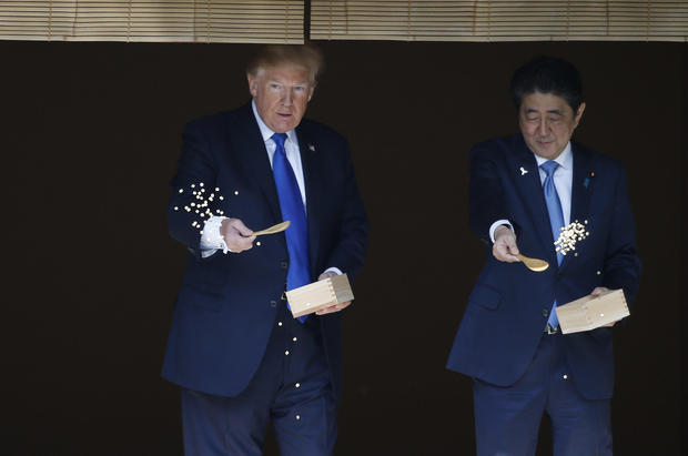 Trump empties box of fish food into Japanese koi pond