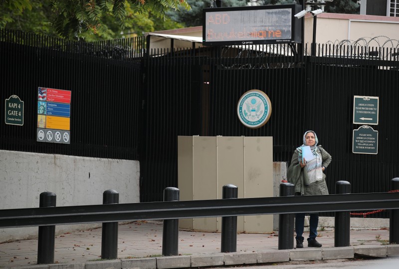 A woman waits in front of the visa application office entrance of the U.S. Embassy in Ankara