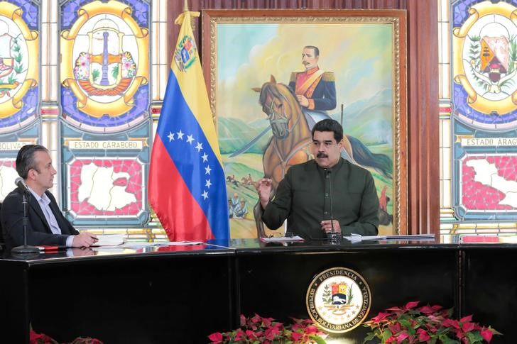 FILE PHOTO - Venezuela's President Nicolas Maduro speak next to Venezuela's Vice President Tareck El Aissami during a meeting with governors in Caracas