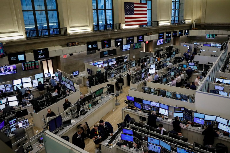 Traders work on the floor of the American Stock Exchange (AMEX) at the NYSE in New York