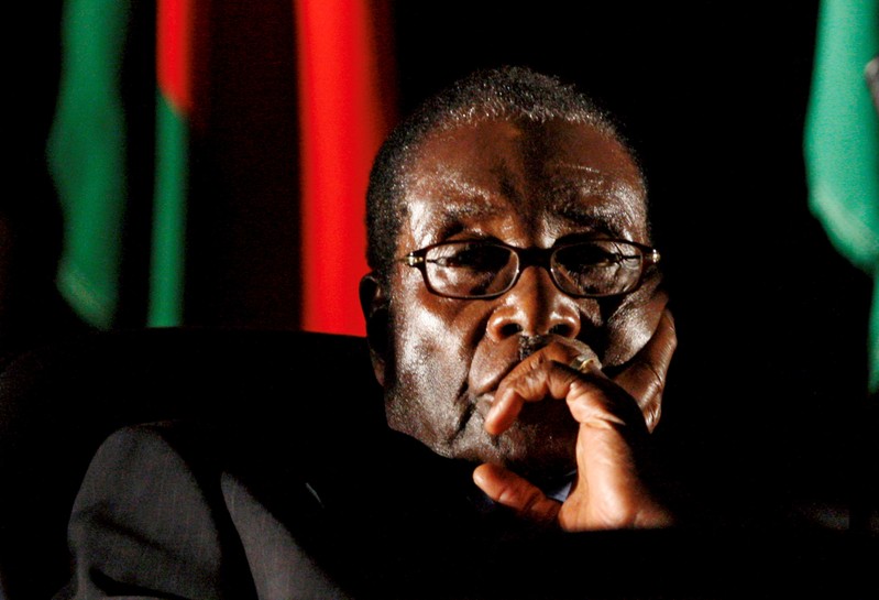 FILE PHOTO: File photo of Zimbabwean President Robert Mugabe watching a video presentation during SADC in Johannesburg