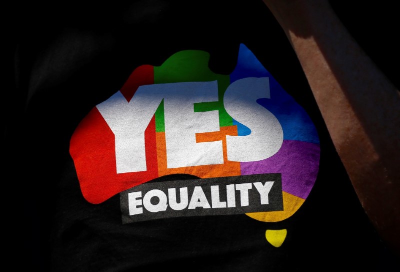 A supporter of the 'Yes' vote for marriage equality wears a shirt as he celebrates after it was announced the majority of Australians support same-sex marriage in a national survey, at a rally in Sydney