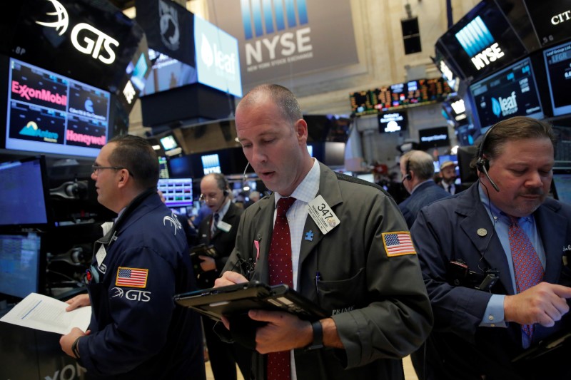 Traders work on the trading floor at the opening of the markets at the NYSE in Manhattan