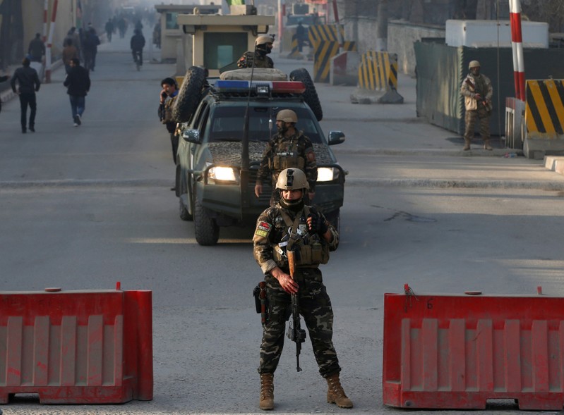 Afghan security forces keep watch at a check point close to compound of Afghanistan's national intelligence agency in Kabul, Afghanistan