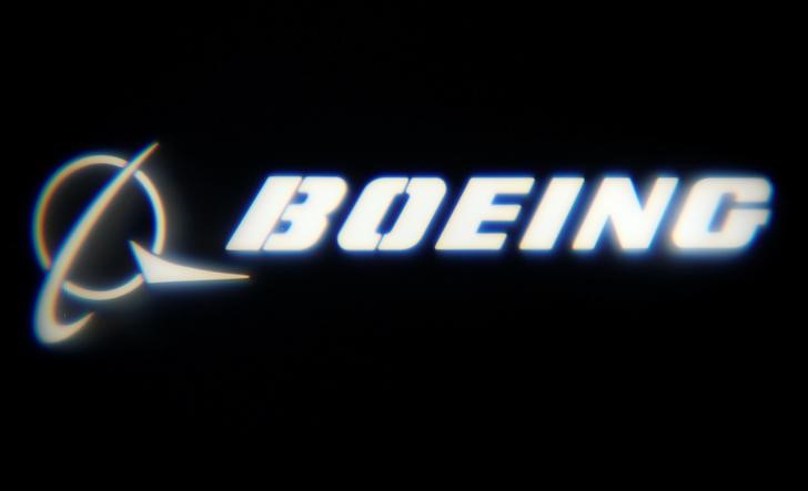 The Boeing Company logo is projected on a wall at the 