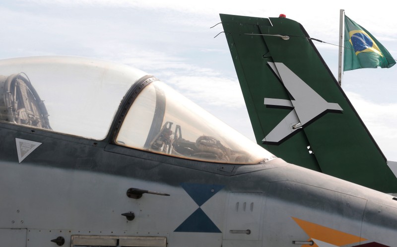 Brazilian national flag is seen behind Embraer jets at the company's plant in Sao Jose dos Campos