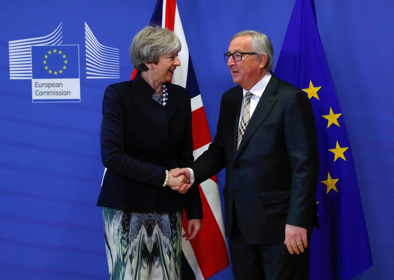 FILE PHOTO - Britain's Prime Minister Theresa May is welcomed by European Commission President Jean-Claude Juncker at the EC headquarters in Brussels